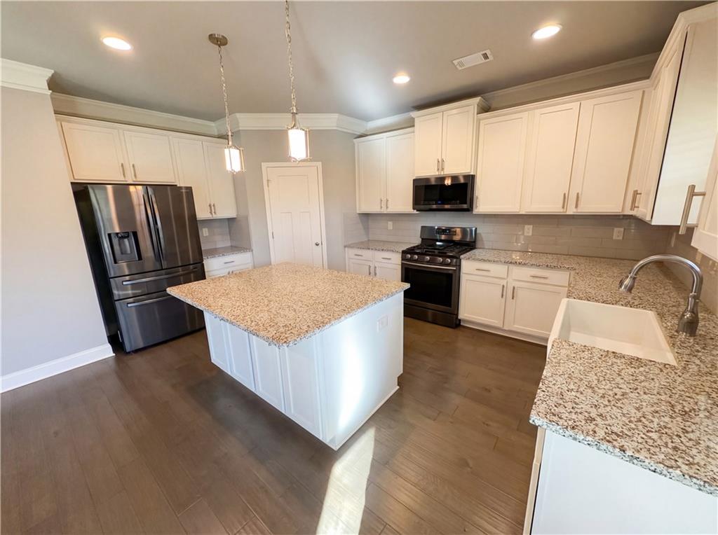 2110 George Bush Lane Jefferson, GA 30549 - Photo 11 of 40 a kitchen with stainless steel appliances granite countertop a refrigerator a stove a sink and a microwave