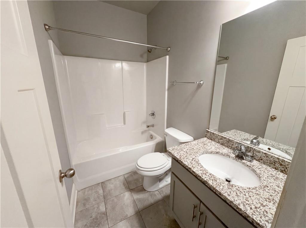 2110 George Bush Lane Jefferson, GA 30549 - Photo 32 of 40 a bathroom with a granite countertop sink toilet and shower