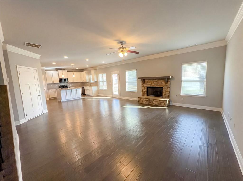 2110 George Bush Lane Jefferson, GA 30549 - Photo 5 of 40 an empty room with wooden floor fireplace and windows