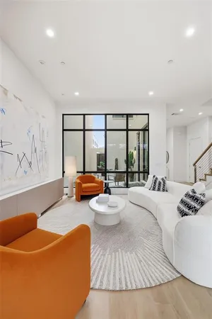 a bedroom with furniture and a large window