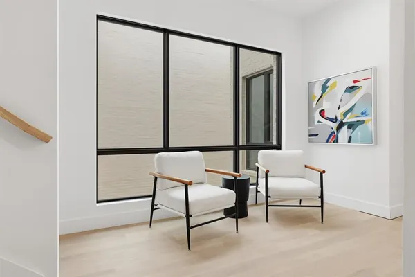 a living room with furniture and a painting on the wall