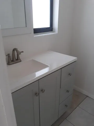 a room with a sink and cabinets