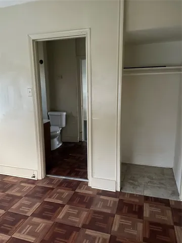 a white toilet sitting next to a bathroom sink