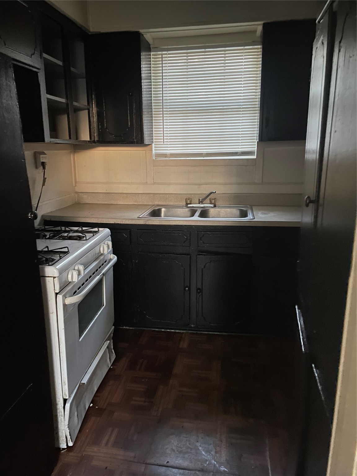 3310 Campbell Street Houston, TX 77026 - Photo 6 of 9 a kitchen with granite countertop a stove and a sink