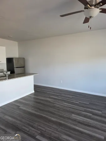 a view of a room with wooden floor and cabinets
