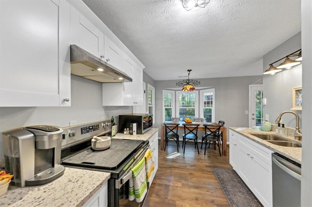 2710 Braemore Place Powder Springs, GA 30127 - Photo 13 of 53 a kitchen with a stove top oven sink and cabinets