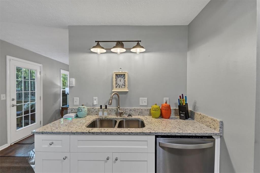 2710 Braemore Place Powder Springs, GA 30127 - Photo 15 of 53 a kitchen with a sink dishwasher and cabinets