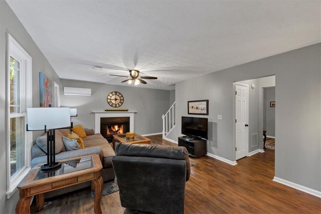 2710 Braemore Place Powder Springs, GA 30127 - Photo 18 of 53 a living room with furniture and a fireplace