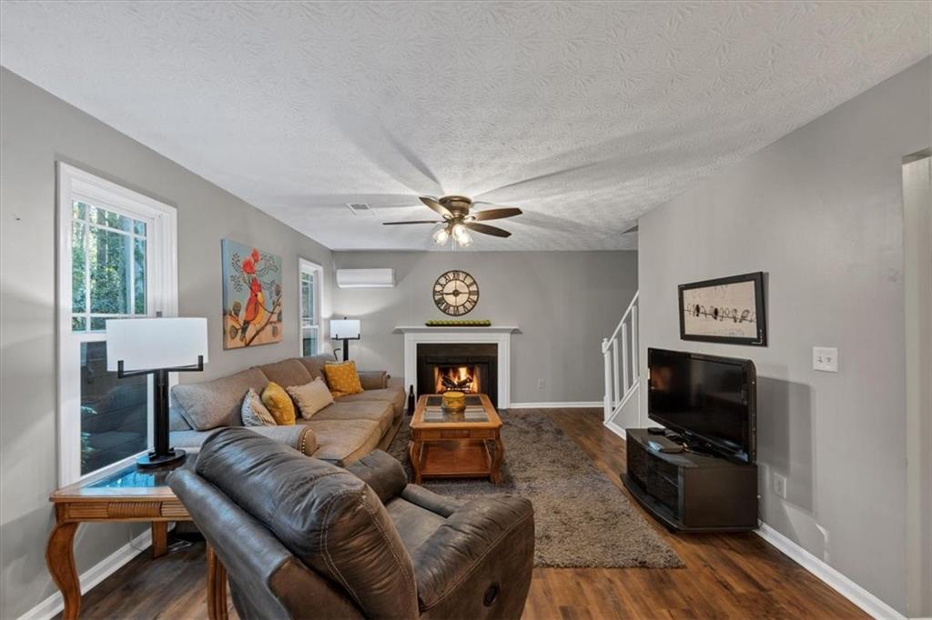 2710 Braemore Place Powder Springs, GA 30127 - Photo 19 of 53 a living room with furniture and a flat screen tv