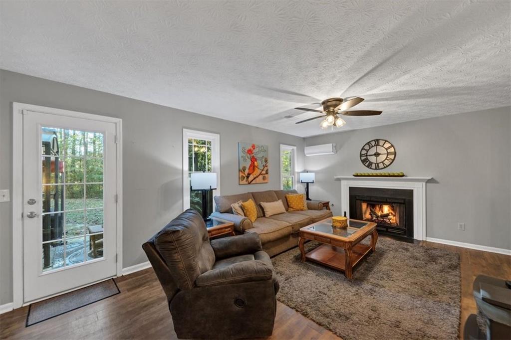 2710 Braemore Place Powder Springs, GA 30127 - Photo 20 of 53 a living room with furniture and a fireplace