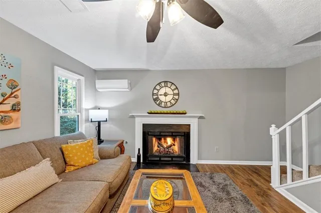 a living room with furniture a rug and a fireplace