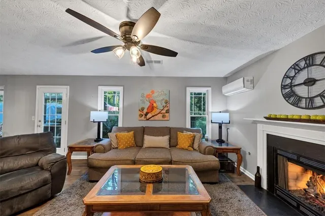a living room with furniture a fireplace and a window