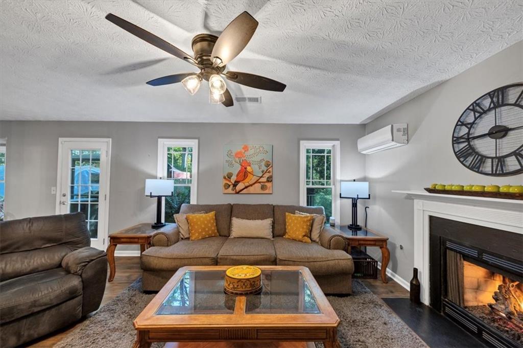 2710 Braemore Place Powder Springs, GA 30127 - Photo 23 of 53 a living room with furniture a fireplace and a window