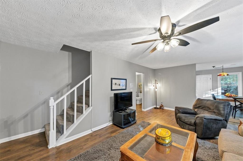2710 Braemore Place Powder Springs, GA 30127 - Photo 24 of 53 a living room with furniture and a fireplace