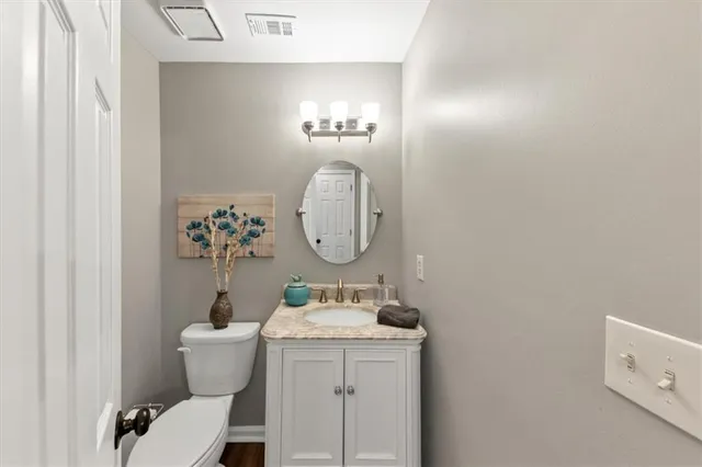 a bedroom with a bed and a mirror on the dresser