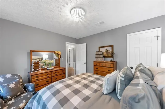 a living room with furniture a flat screen tv and a window