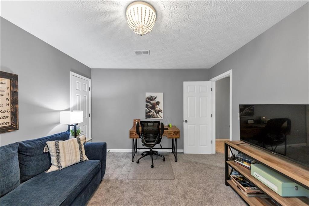 2710 Braemore Place Powder Springs, GA 30127 - Photo 29 of 53 a living room with furniture