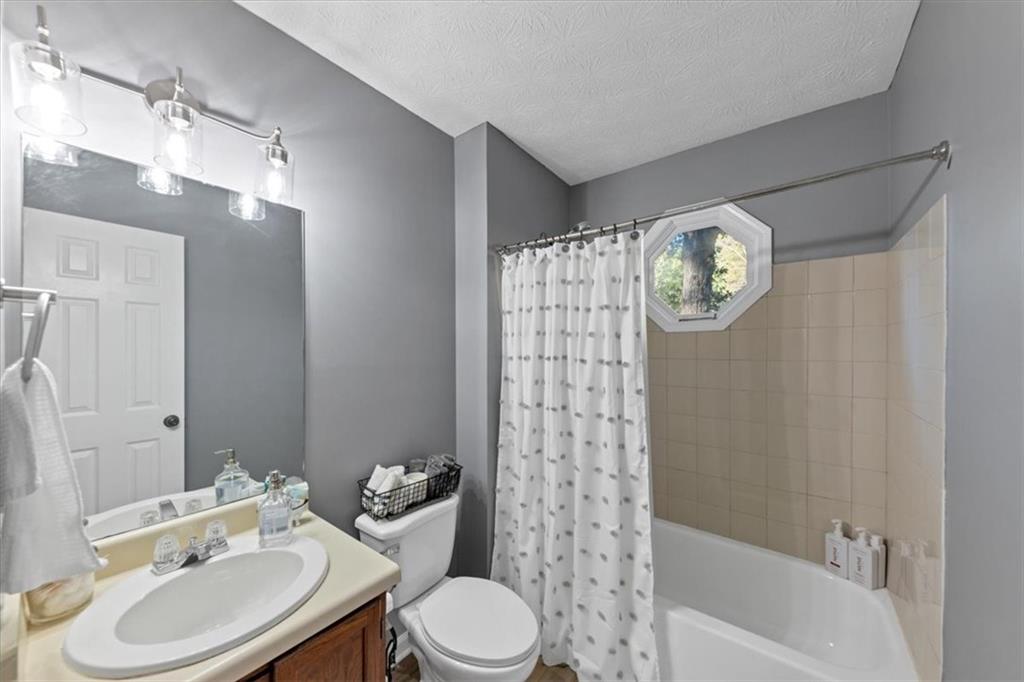 2710 Braemore Place Powder Springs, GA 30127 - Photo 30 of 53 a bathroom with a sink toilet and shower