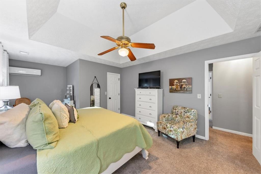 2710 Braemore Place Powder Springs, GA 30127 - Photo 33 of 53 a bedroom with a bed and a ceiling fan