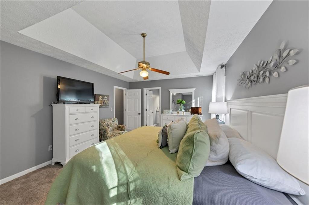 2710 Braemore Place Powder Springs, GA 30127 - Photo 34 of 53 a bedroom with a bed and a flat screen tv