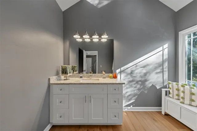 a hallway with wooden floor and furniture