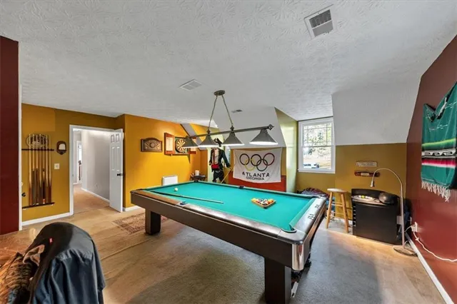 a view of a patio with table and chairs under an umbrella