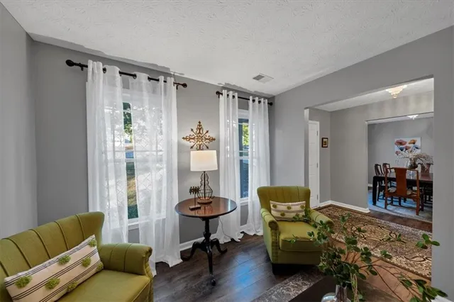 a living room with furniture and a chandelier