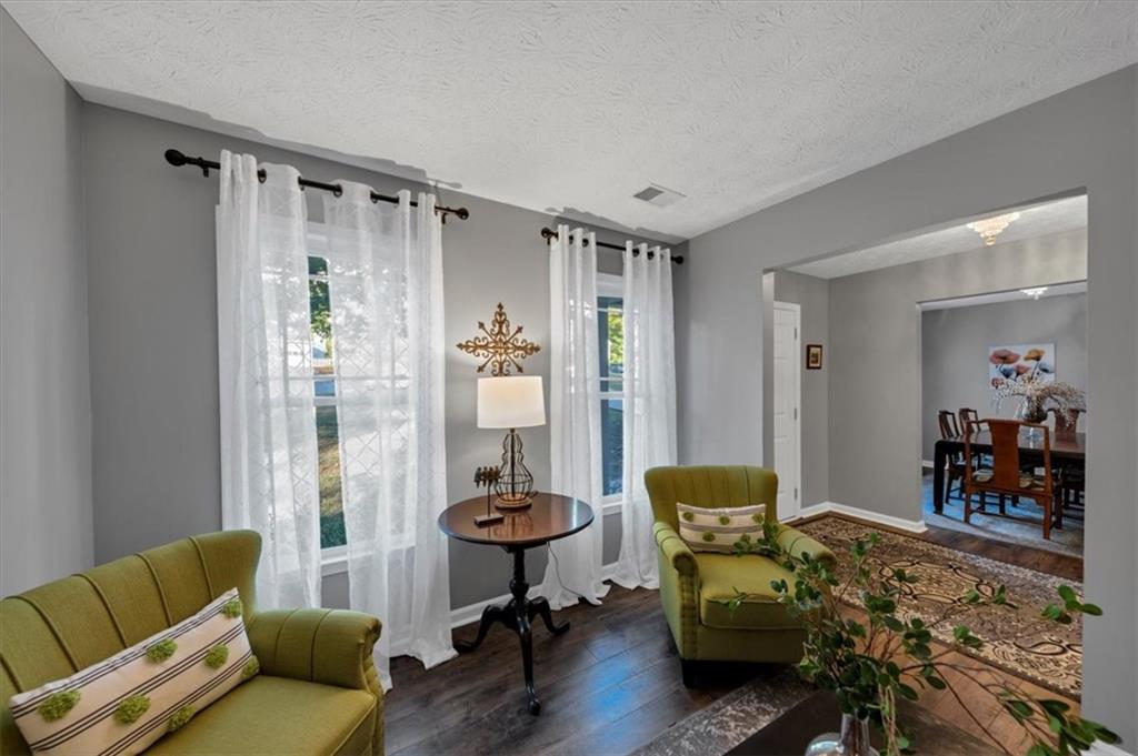 2710 Braemore Place Powder Springs, GA 30127 - Photo 9 of 53 a living room with furniture and a chandelier