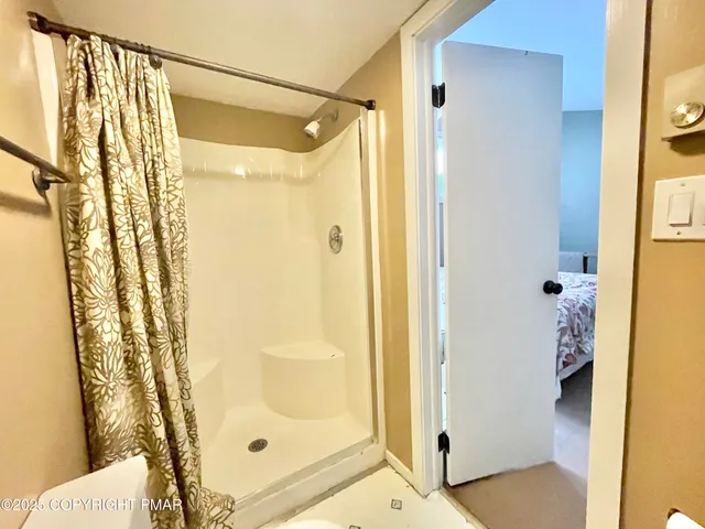 a bathroom with a glass shower door and a sink