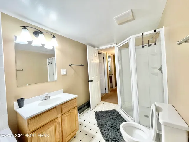 a bathroom with a sink and mirror with toilet