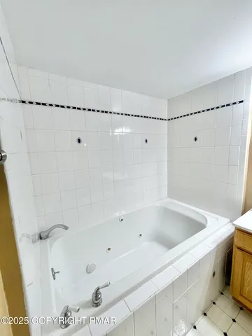 a bathroom with a bathtub and a shower