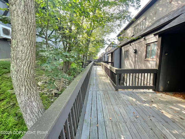 a view of balcony with wooden floor and fence