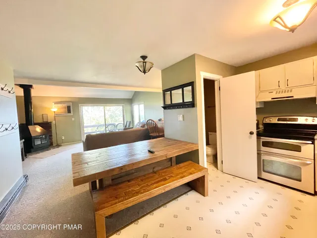 a room with pool table and windows