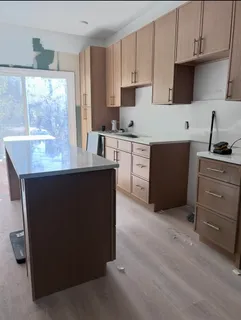a kitchen with a sink stove and cabinets