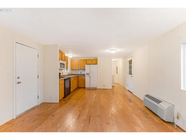 a view of a kitchen with wooden floor