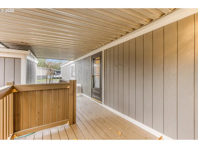 a kitchen with stainless steel appliances granite countertop a stove top oven a sink dishwasher and a refrigerator with wooden floor