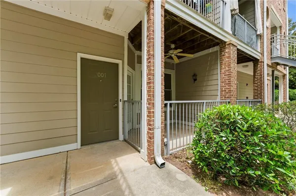 a view of a house with a door and wooden bench