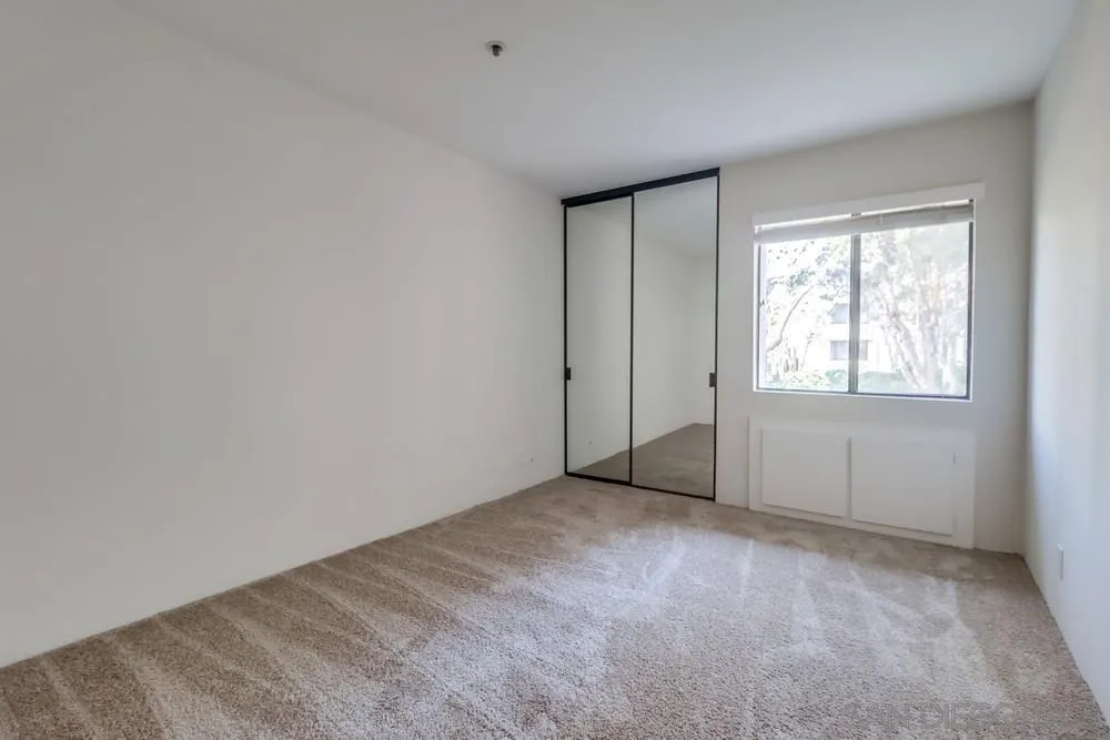 5665 Friars Road, Unit 219 San Diego, CA 92110 - Photo 12 of 34 an empty room with windows