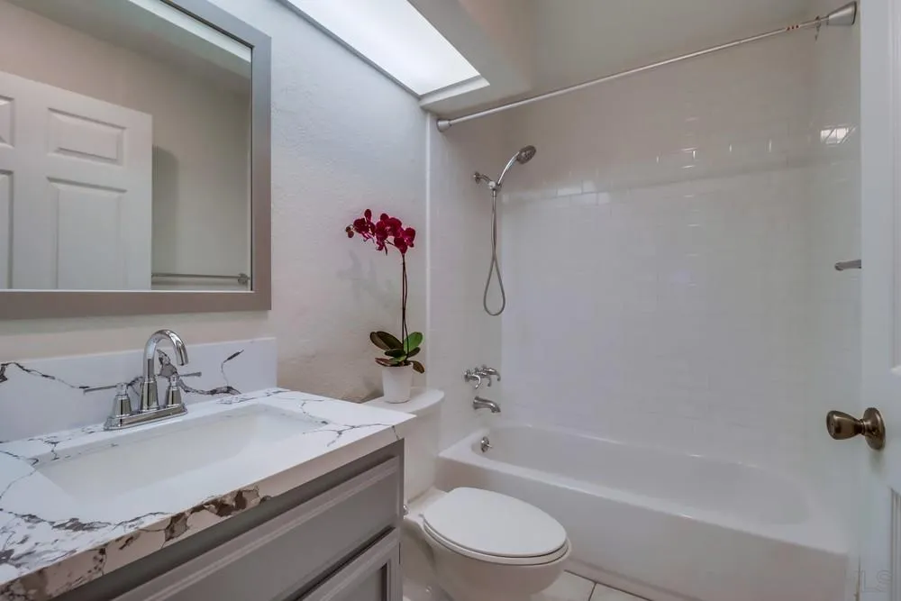 5665 Friars Road, Unit 219 San Diego, CA 92110 - Photo 13 of 34 a bathroom with a sink a toilet and a bathtub