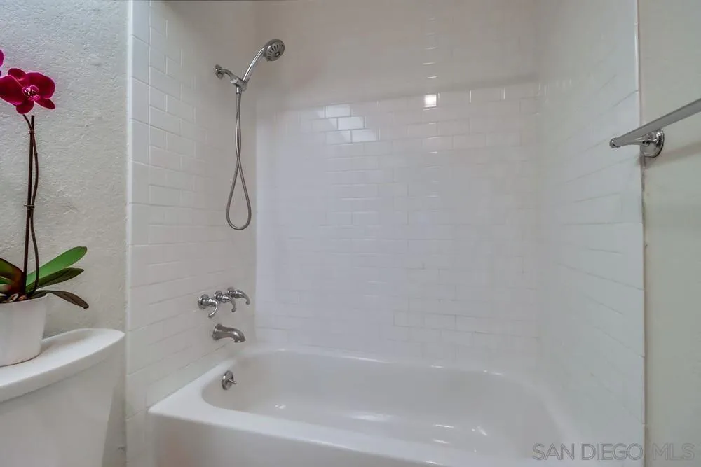 5665 Friars Road, Unit 219 San Diego, CA 92110 - Photo 14 of 34 a bathroom with a bath tub with a shower