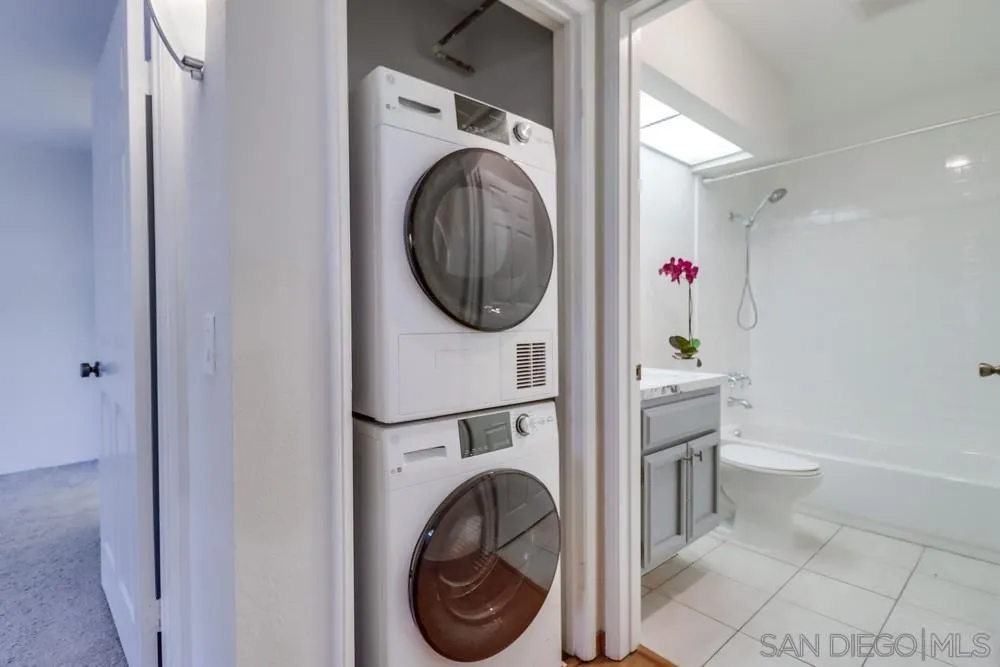 5665 Friars Road, Unit 219 San Diego, CA 92110 - Photo 15 of 34 a view of a hallway with washer and dryer