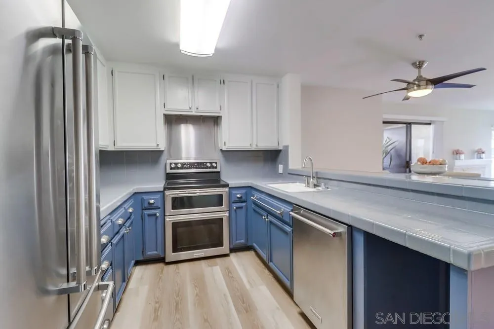 5665 Friars Road, Unit 219 San Diego, CA 92110 - Photo 2 of 34 a kitchen with a stove sink and refrigerator