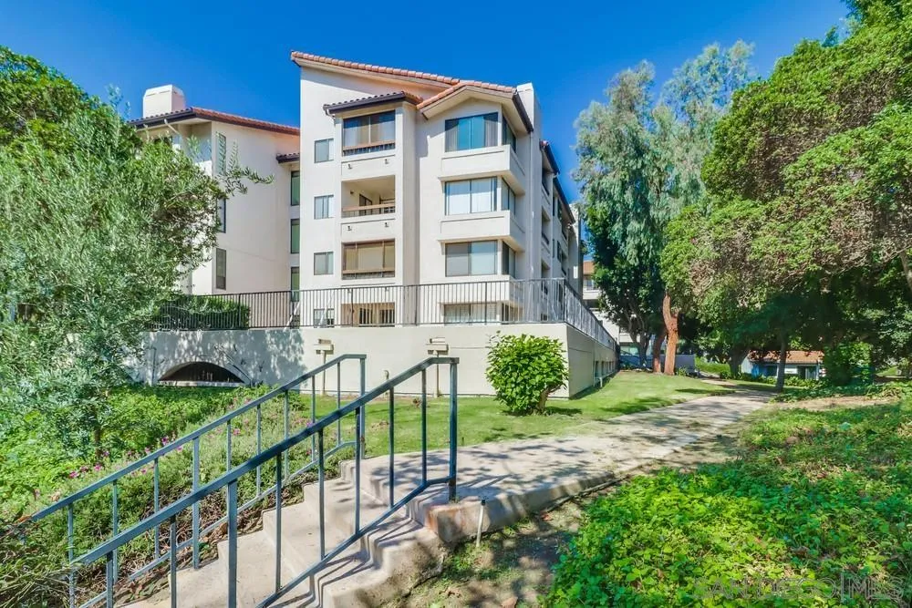 5665 Friars Road, Unit 219 San Diego, CA 92110 - Photo 26 of 34 a view of a brick building next to a yard