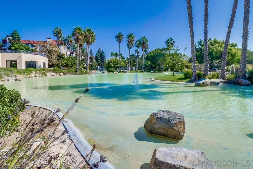 5665 Friars Road, Unit 219 San Diego, CA 92110 - Photo 31 of 34 a view of a backyard with plants and a lake view