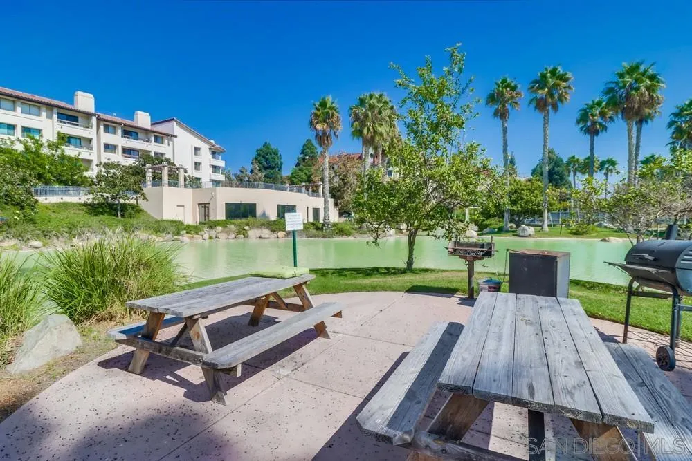 5665 Friars Road, Unit 219 San Diego, CA 92110 - Photo 32 of 34 a view of a patio with a table and chairs