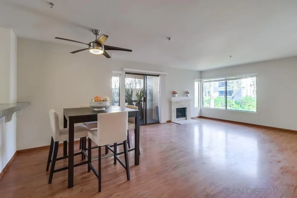 5665 Friars Road, Unit 219 San Diego, CA 92110 - Photo 5 of 34 a view of a dining room with furniture window and wooden floor