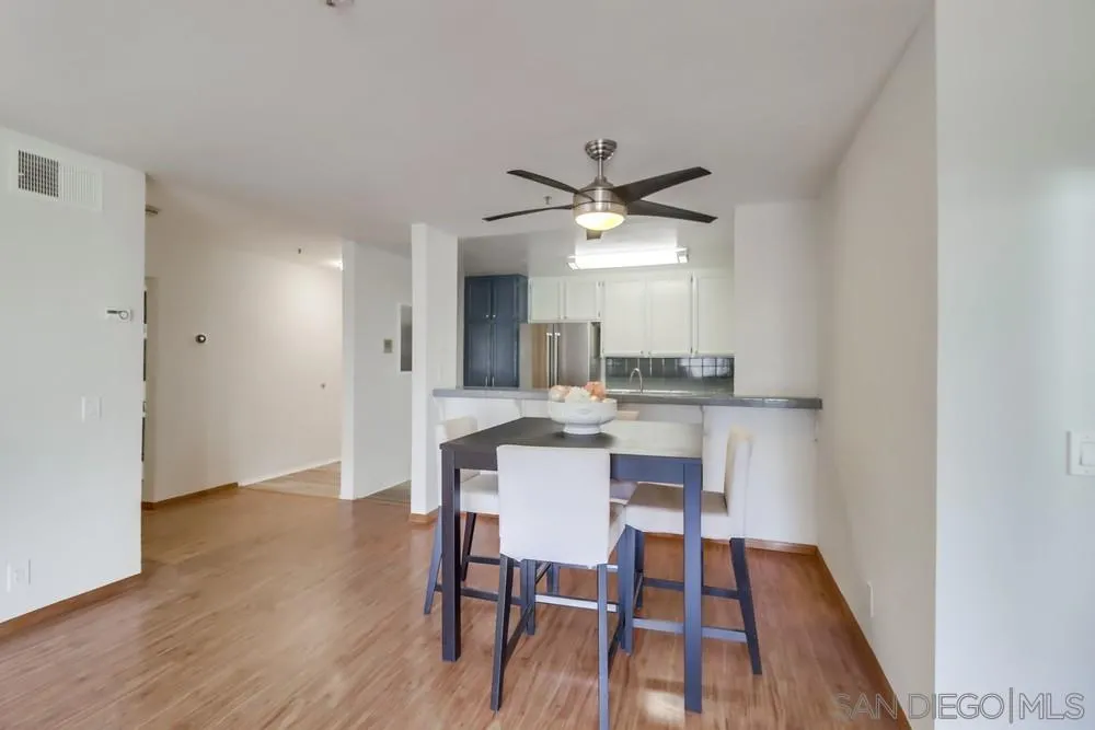 5665 Friars Road, Unit 219 San Diego, CA 92110 - Photo 6 of 34 a view of a dining room with furniture and wooden floor