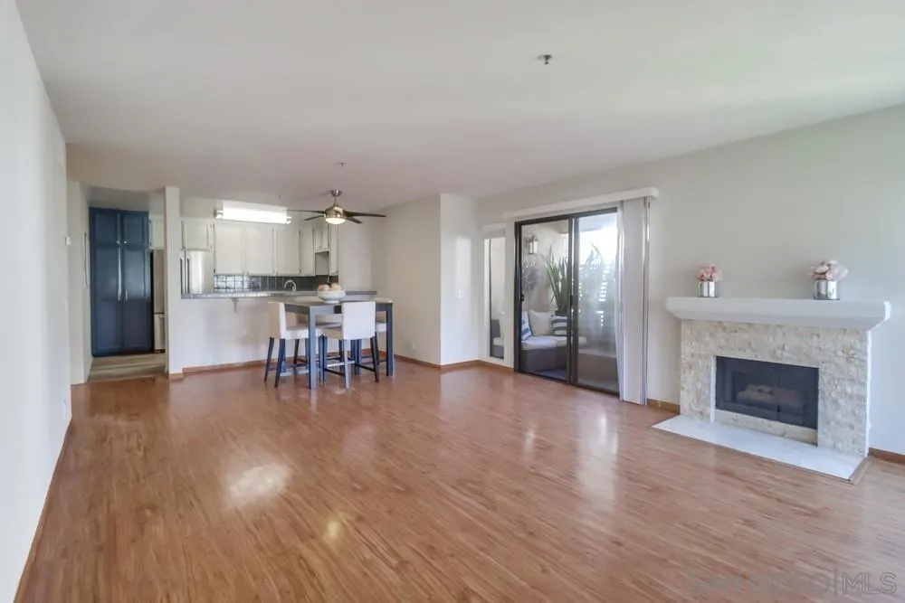 5665 Friars Road, Unit 219 San Diego, CA 92110 - Photo 7 of 34 a view of a kitchen with dining table and chairs