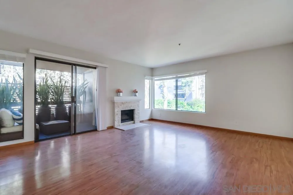 5665 Friars Road, Unit 219 San Diego, CA 92110 - Photo 8 of 34 a view of an empty room with wooden floor and a window