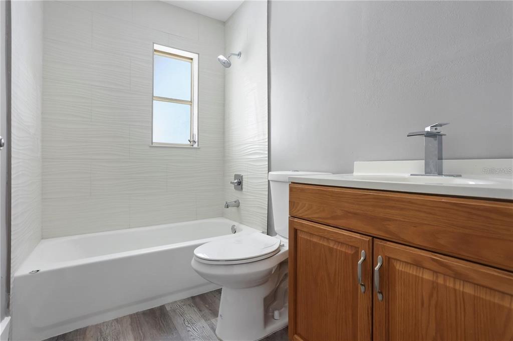 6615 Renssalaer Drive Bradenton, FL 34207 - Photo 12 of 31 a bathroom with a sink a toilet and shower